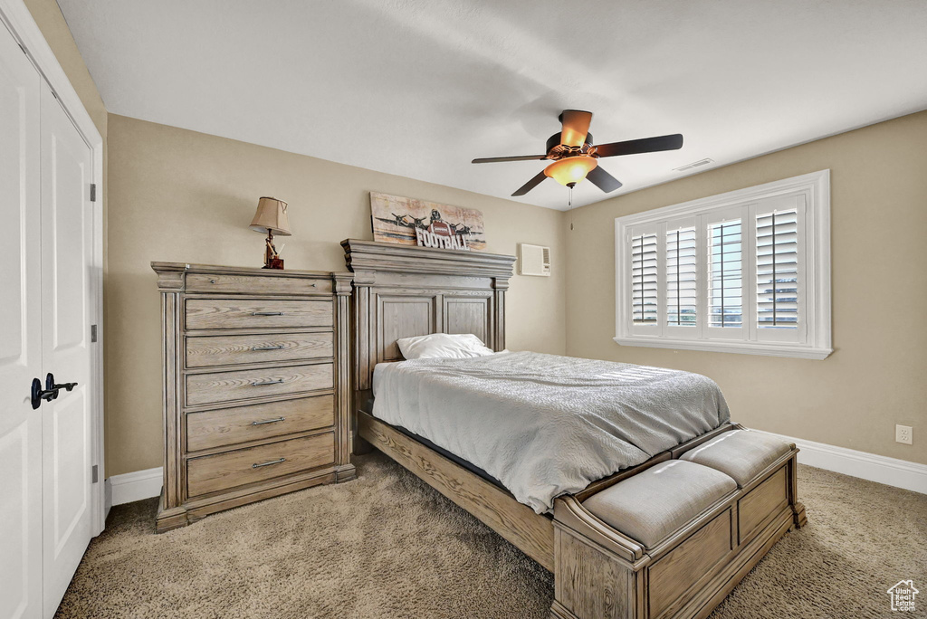 Bedroom featuring light carpet, a closet, and ceiling fan