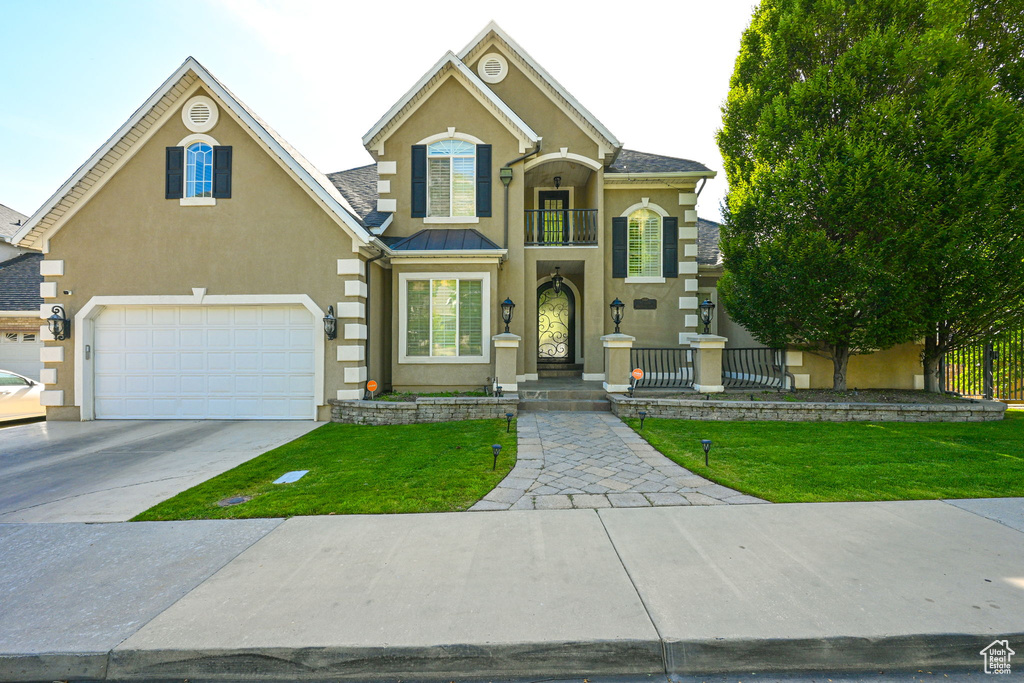 View of front of property with a garage and a balcony