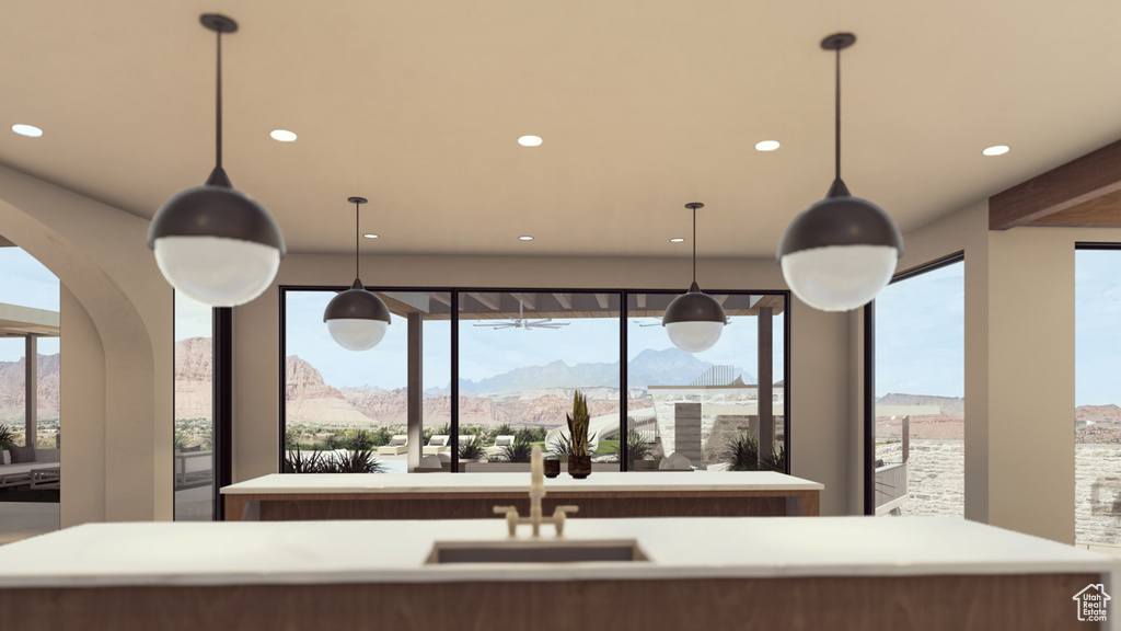 Kitchen featuring pendant lighting, sink, a kitchen island with sink, and a mountain view