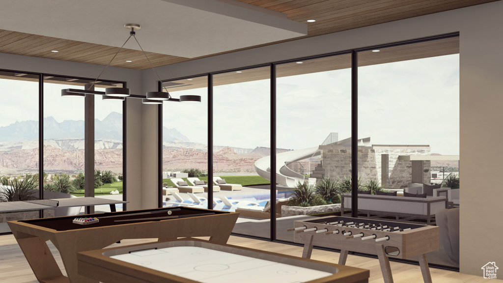 Sunroom / solarium with wood ceiling and a mountain view