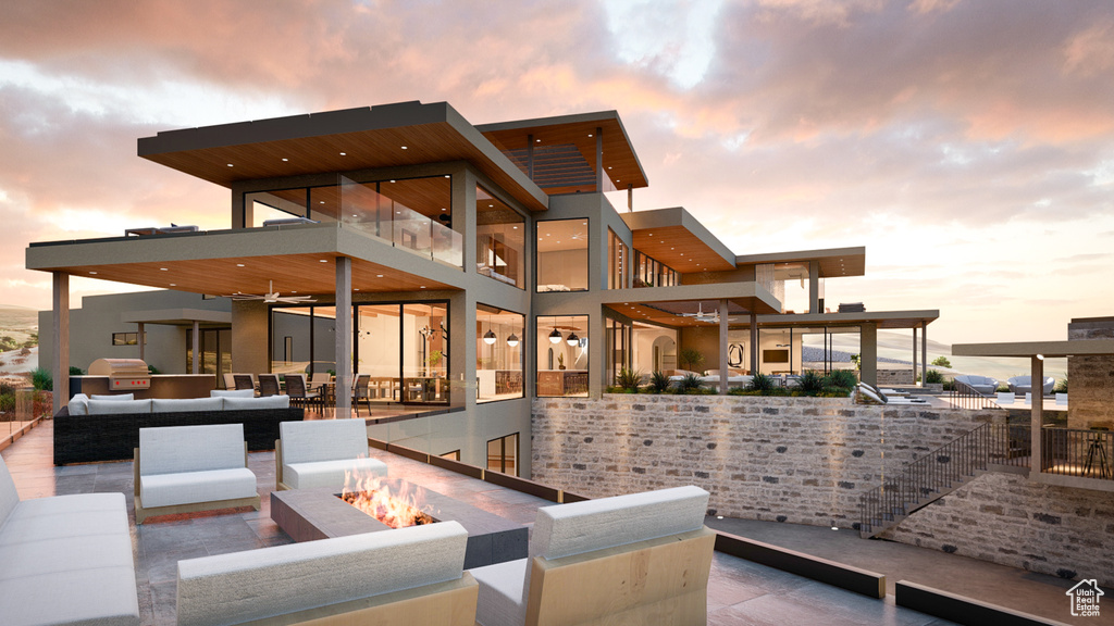 Exterior space featuring an outdoor living space with a fire pit and area for grilling