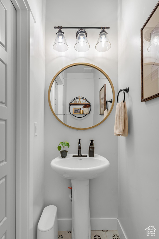 Bathroom with toilet and tile patterned flooring