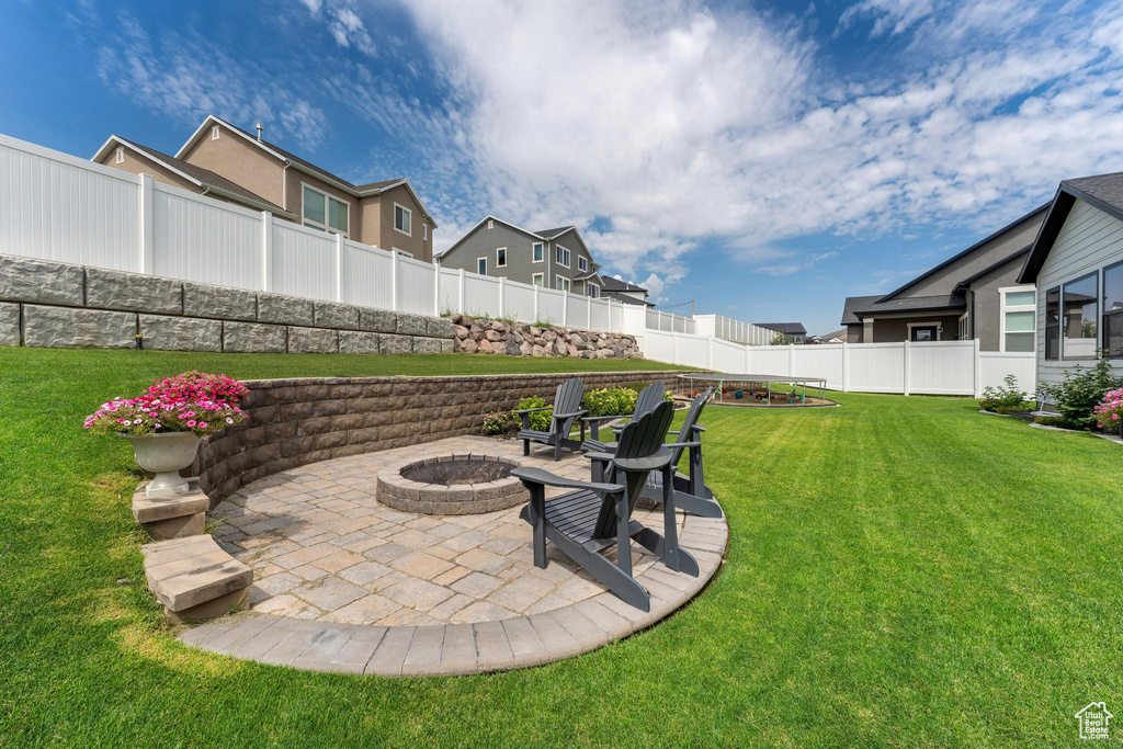 View of yard with a patio area and an outdoor fire pit