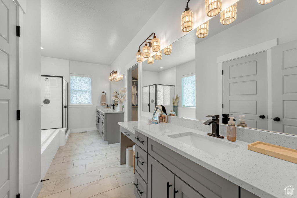 Bathroom featuring tile patterned floors, vanity, and plenty of natural light