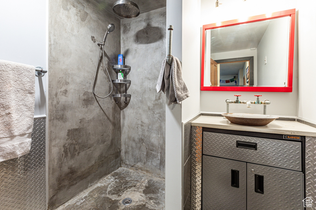 Bathroom with tiled shower and vanity