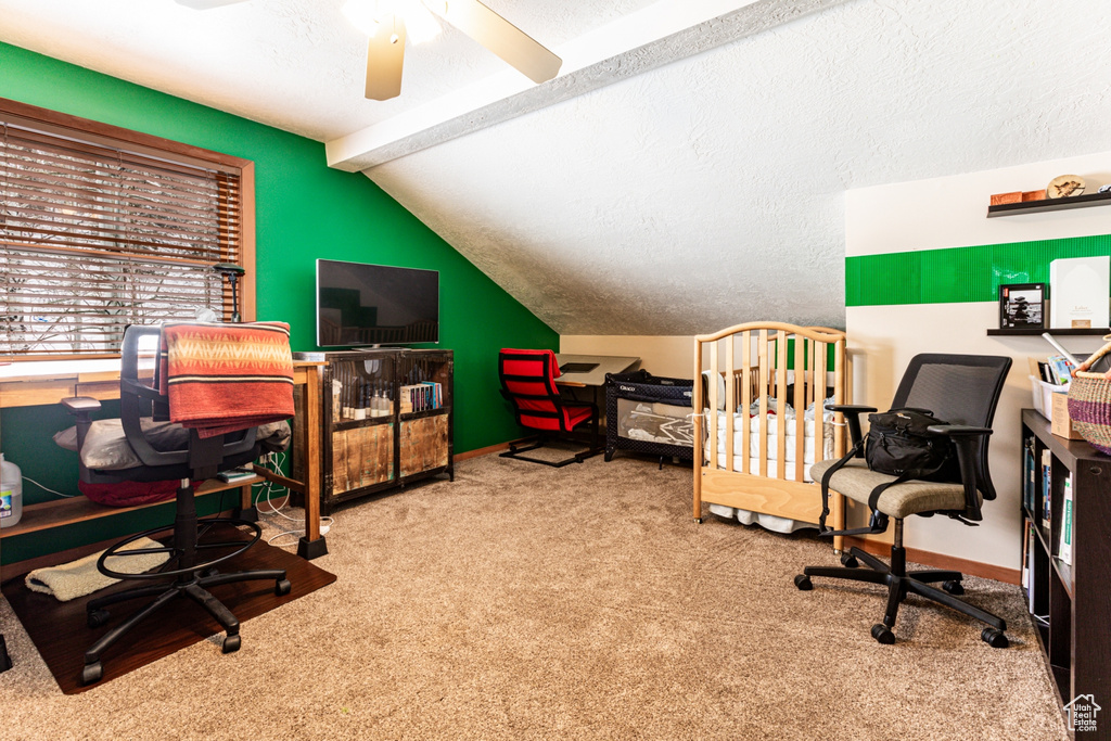 Carpeted office featuring a textured ceiling, ceiling fan, and lofted ceiling