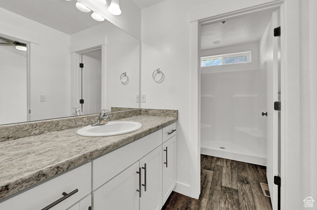 Bathroom with hardwood / wood-style flooring and vanity