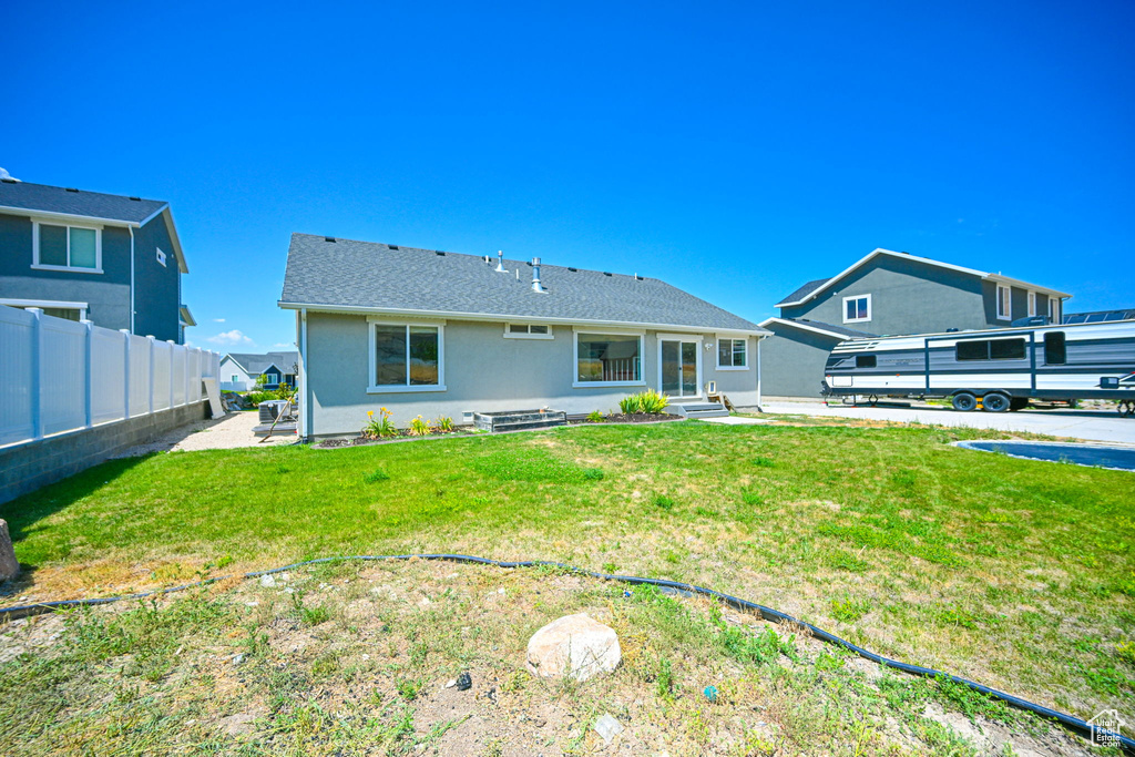 Back of property featuring a patio area and a yard