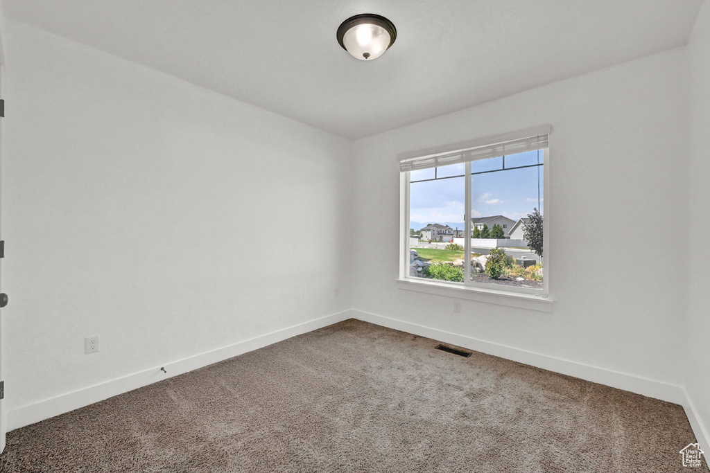 Unfurnished room featuring carpet flooring