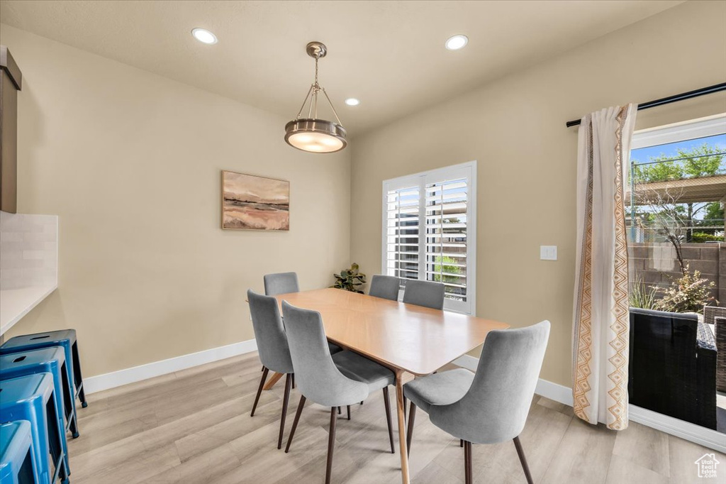 Dining area with a healthy amount of sunlight and light hardwood / wood-style floors