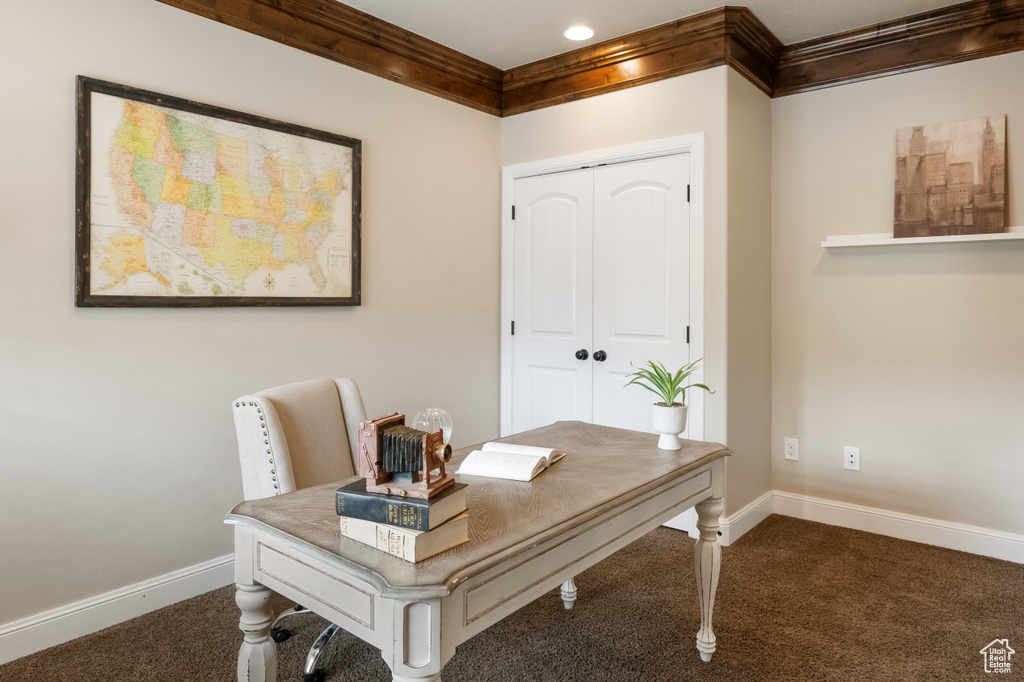 Carpeted home office with crown molding