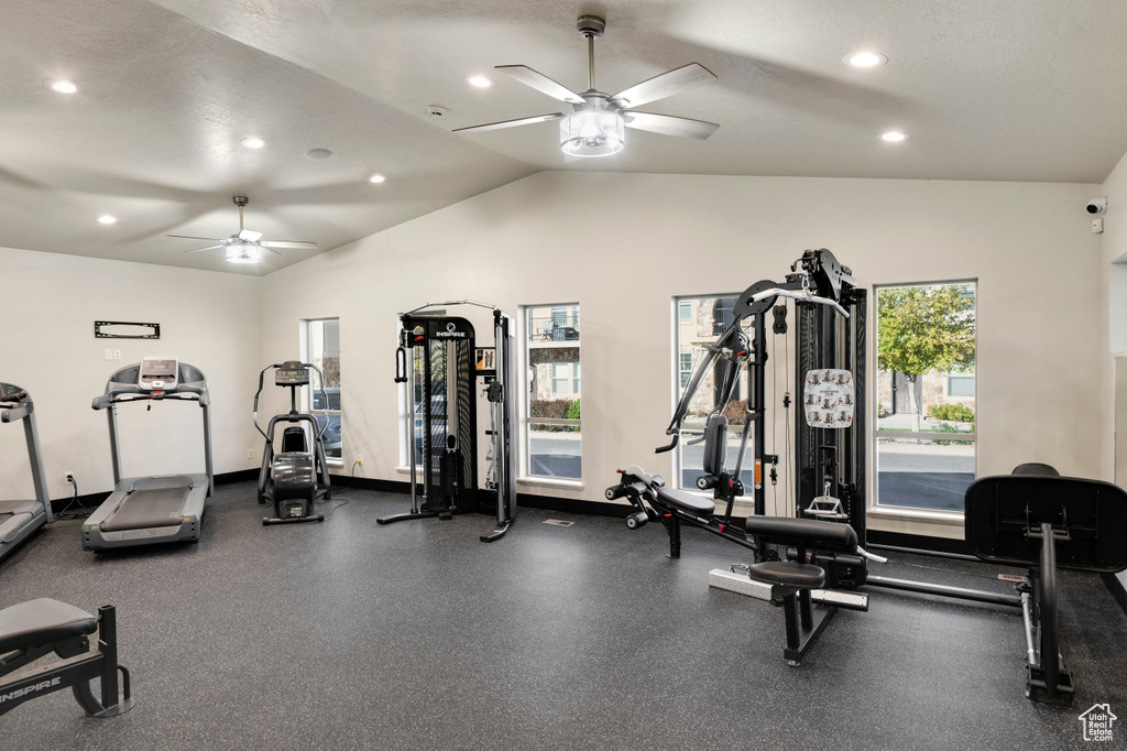 Exercise room with vaulted ceiling, ceiling fan, and a textured ceiling