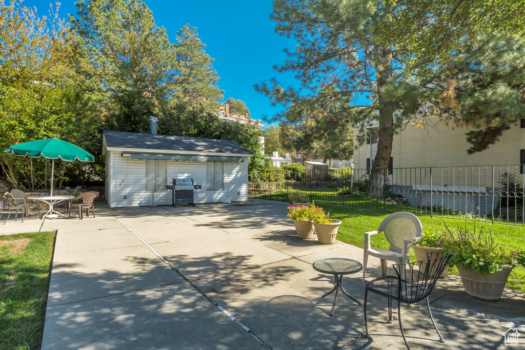 View of patio with a grill