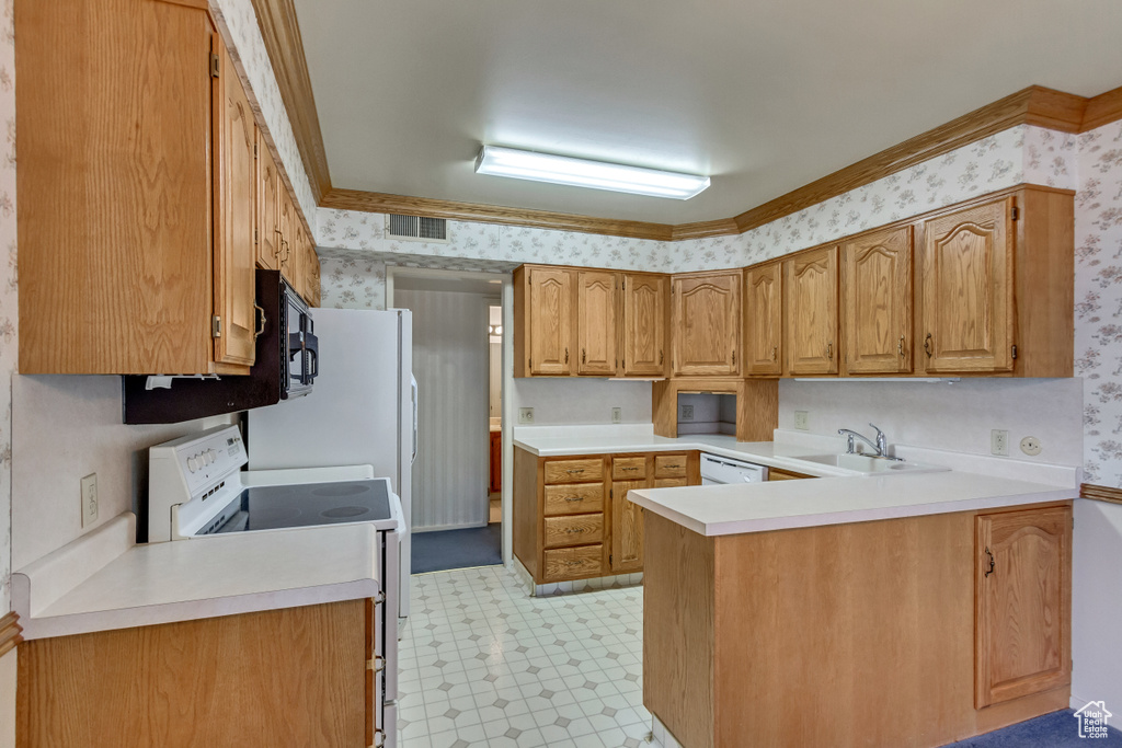 Kitchen with sink, light tile patterned flooring, kitchen peninsula, and white appliances