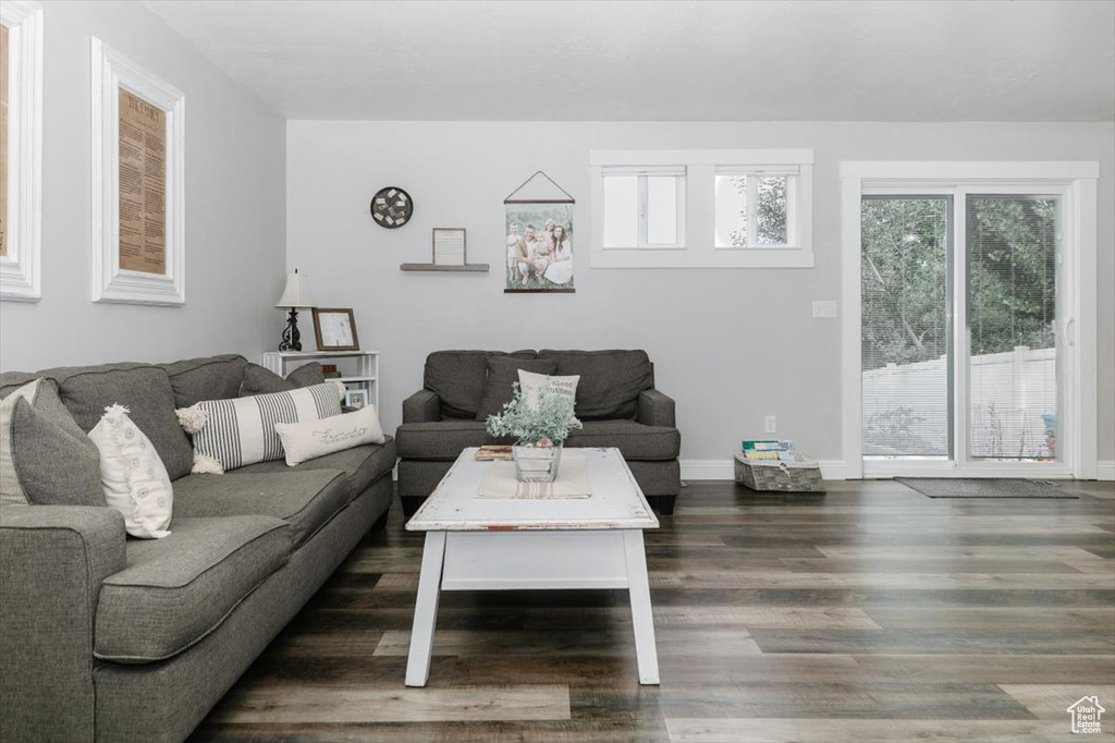 Living room with dark wood-type flooring