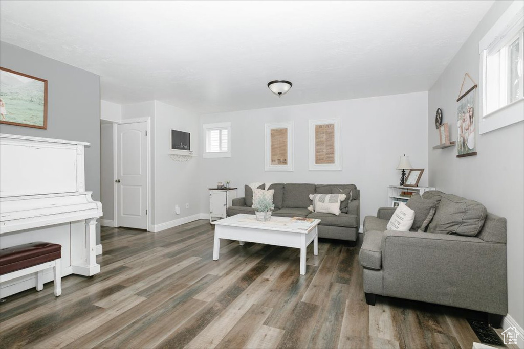 Living room featuring dark hardwood / wood-style floors and a healthy amount of sunlight