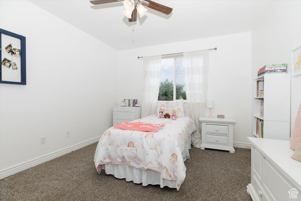 Carpeted bedroom featuring ceiling fan