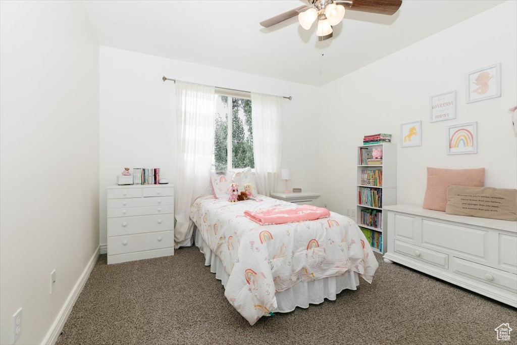 Carpeted bedroom featuring ceiling fan