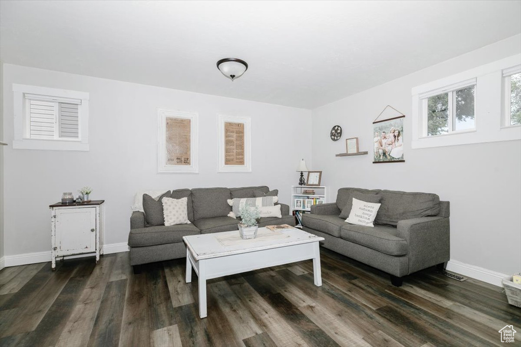 Living room with dark hardwood / wood-style flooring