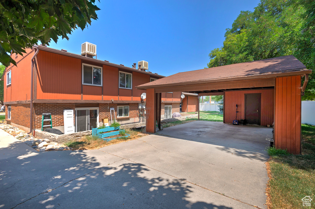 View of front of house featuring cooling unit and a carport