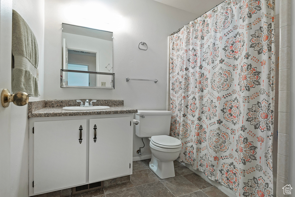 Bathroom with tile patterned flooring, toilet, and vanity