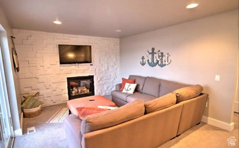 Carpeted living room with a fireplace