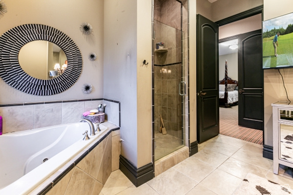 Bathroom with independent shower and bath and tile patterned floors