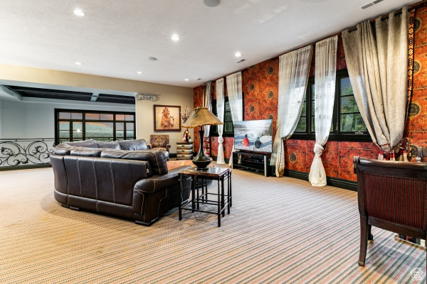 Carpeted living room featuring a wealth of natural light