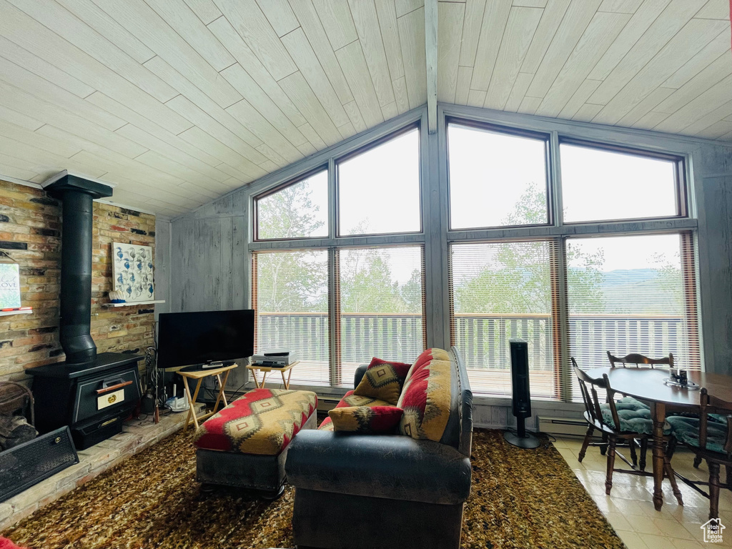 Tiled living room featuring wooden ceiling, a wood stove, and lofted ceiling