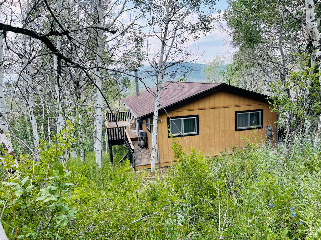 View of side of property with a deck