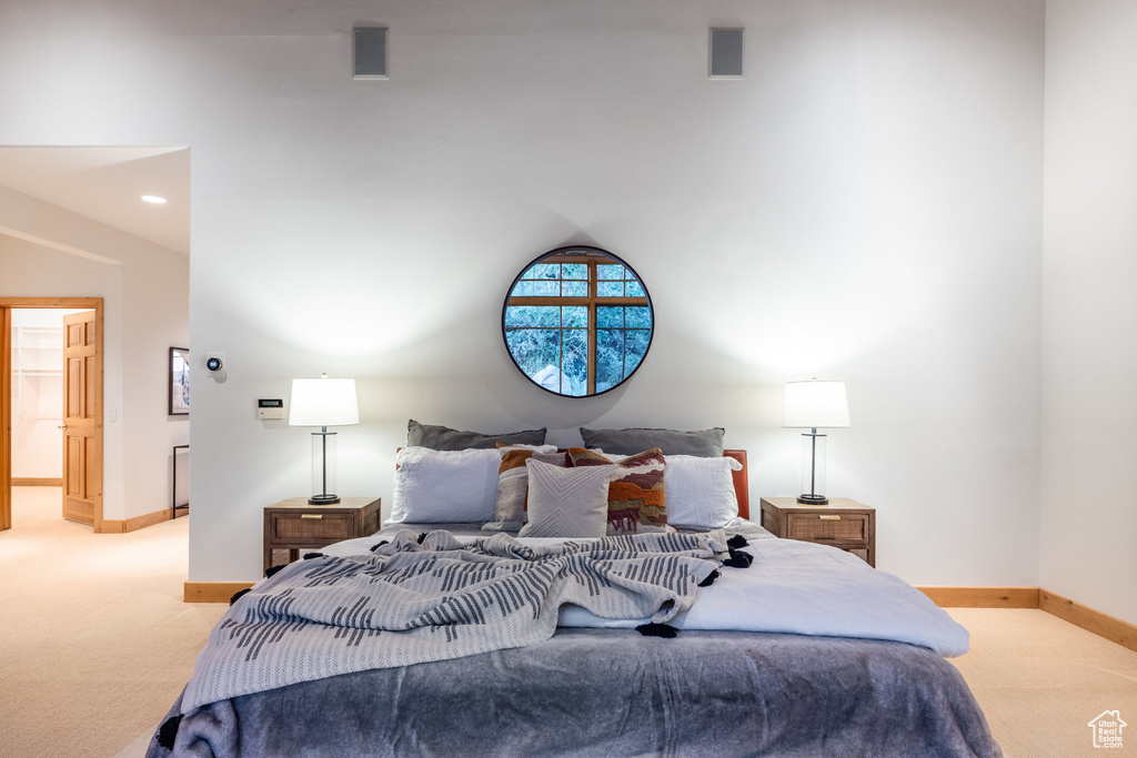 Carpeted bedroom featuring connected bathroom