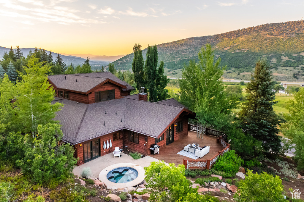 Aerial view at dusk featuring a mountain view