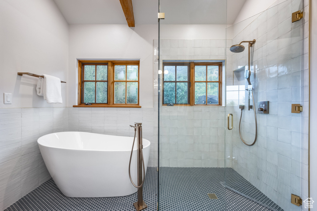 Bathroom with tile walls and separate shower and tub