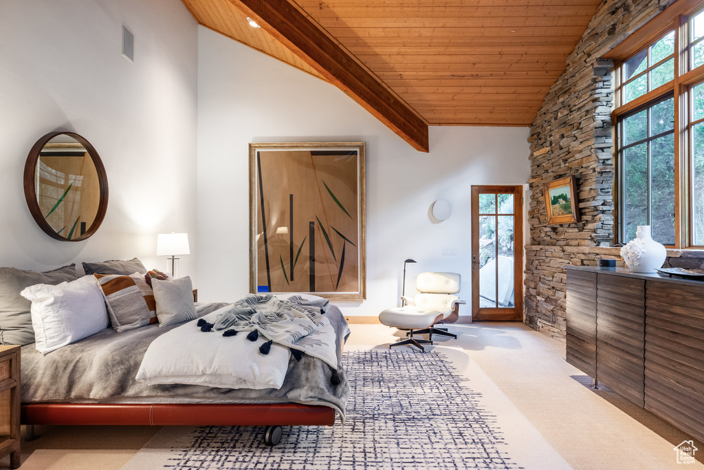 Carpeted bedroom featuring beam ceiling, high vaulted ceiling, and wooden ceiling