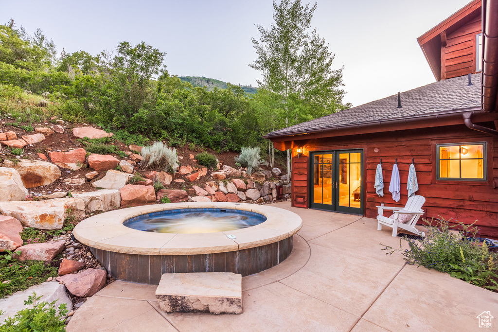 View of patio featuring an outdoor hot tub