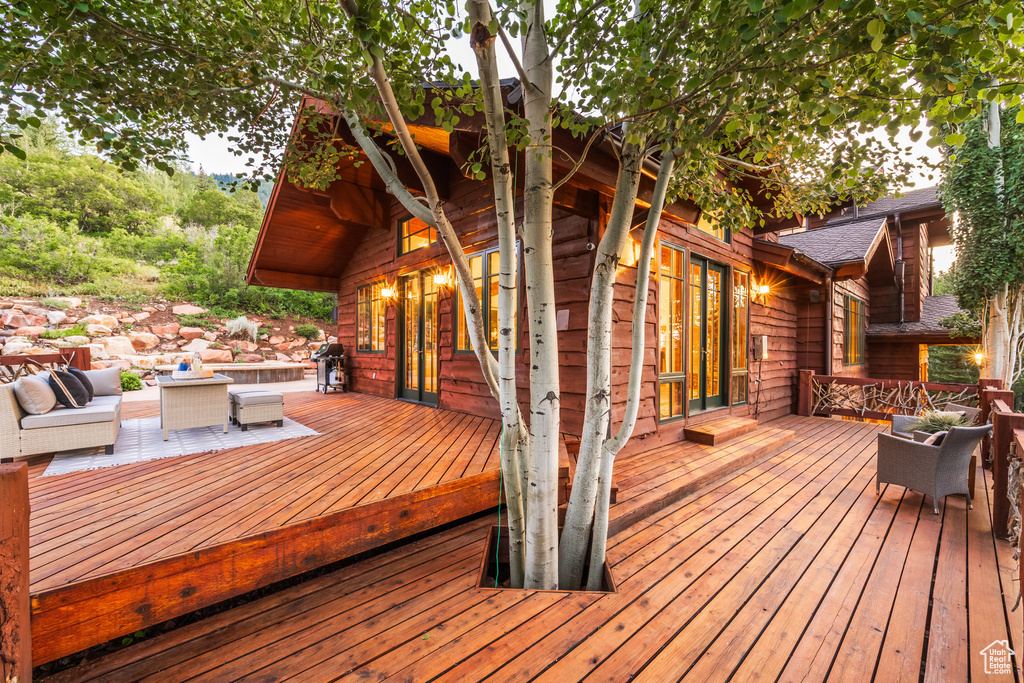 Wooden terrace featuring an outdoor hangout area