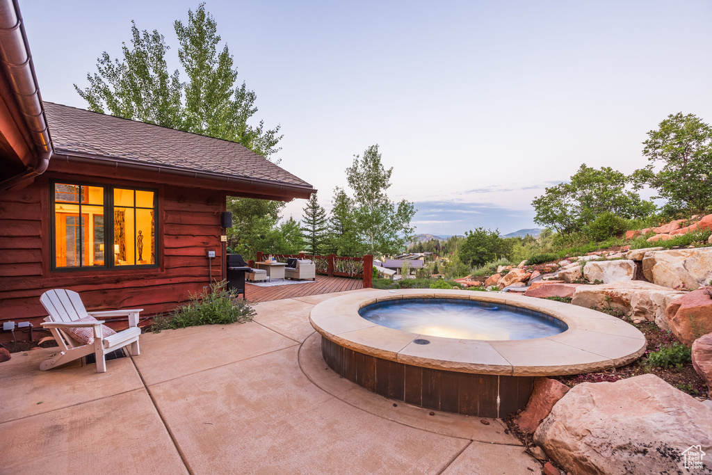 View of pool with a patio area, an in ground hot tub, and a wooden deck