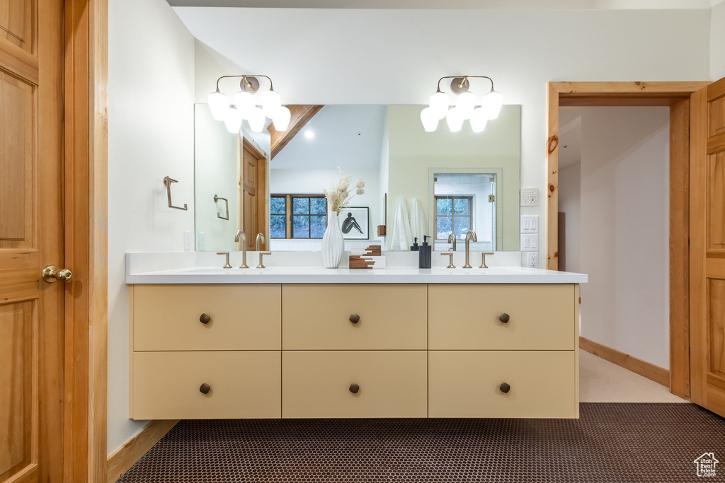 Bathroom with double vanity and a notable chandelier