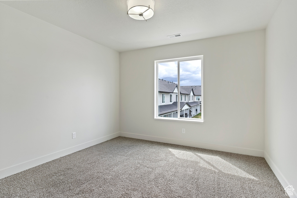 Unfurnished room with carpet