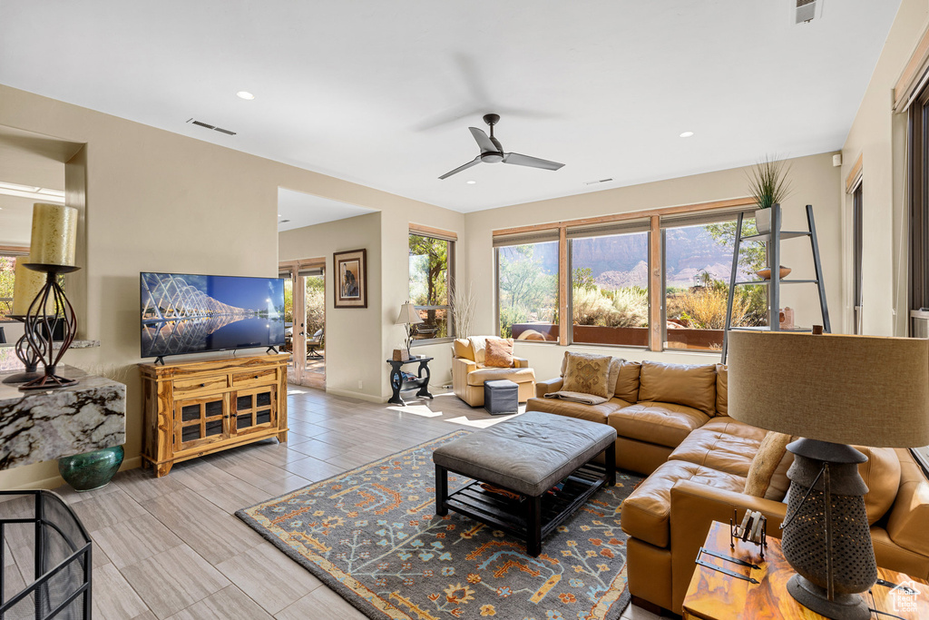 Living room featuring ceiling fan and light wood-type flooring