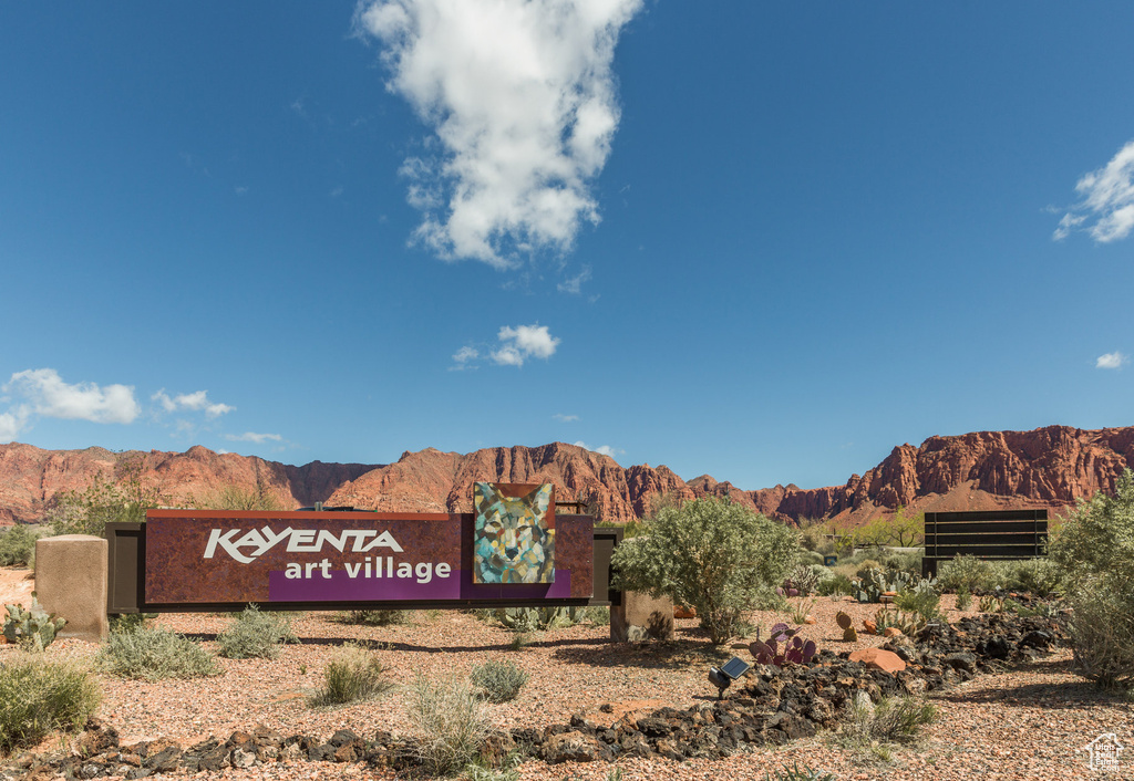 Community / neighborhood sign featuring a mountain view