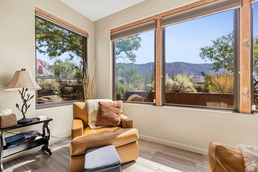 Sitting room with light hardwood / wood-style flooring and a mountain view