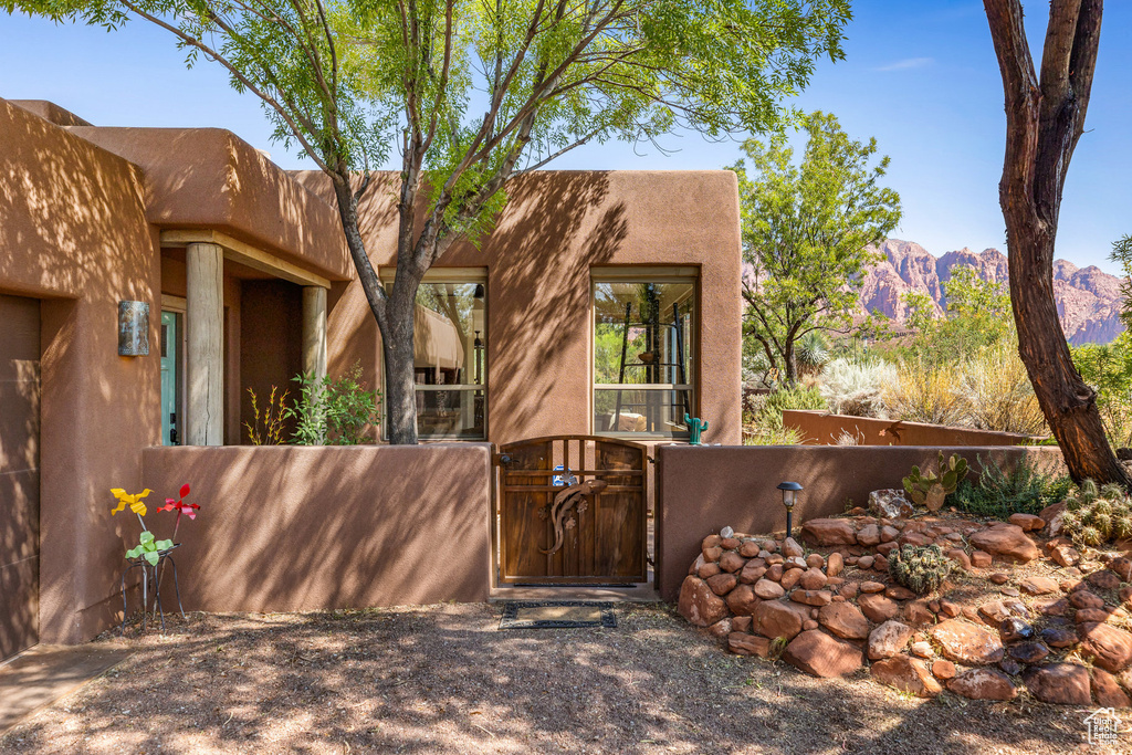 Pueblo-style home featuring a mountain view