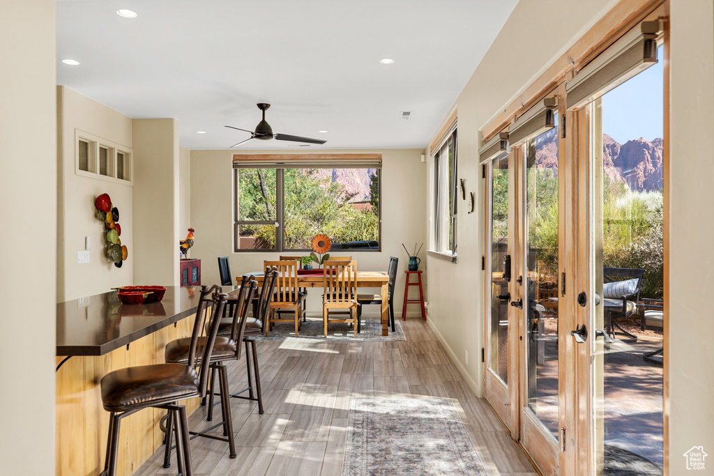 Dining room with wood-type flooring and ceiling fan