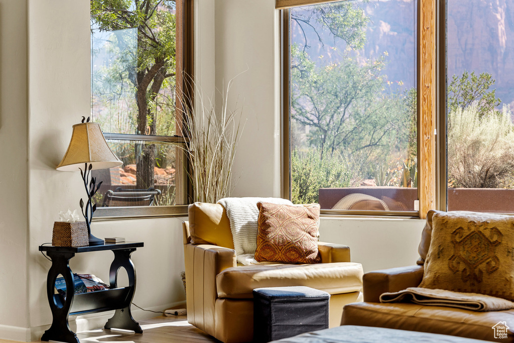 Living area featuring a healthy amount of sunlight and hardwood / wood-style floors