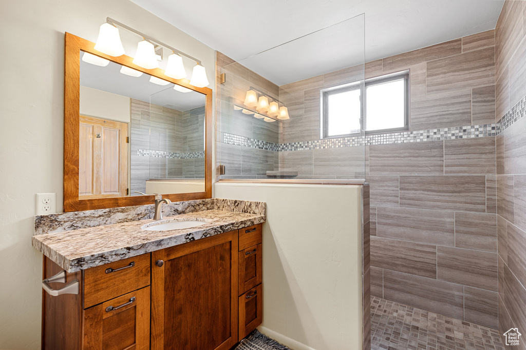 Bathroom featuring vanity and a tile shower