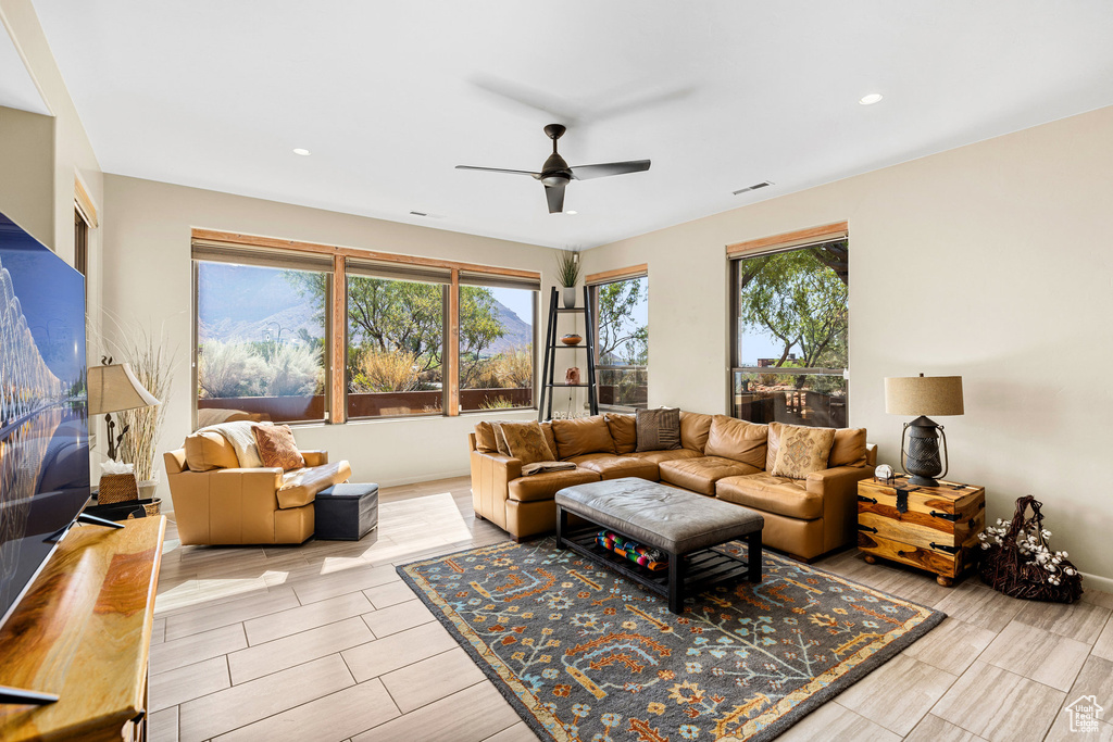 Living room featuring ceiling fan, a healthy amount of sunlight, and hardwood / wood-style floors