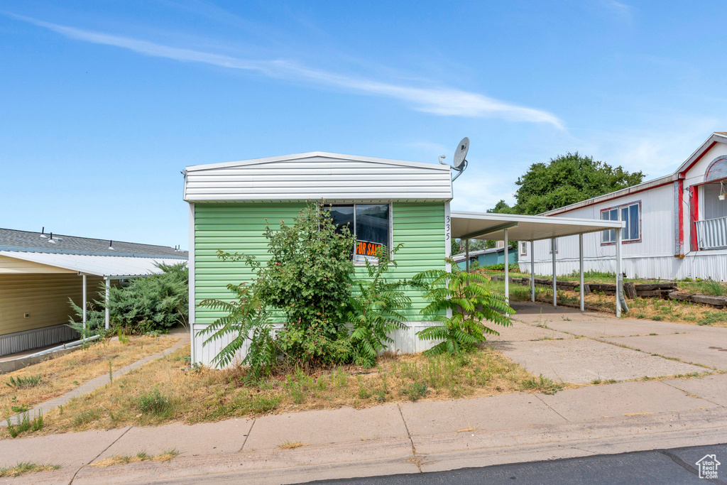 View of front of house with a carport