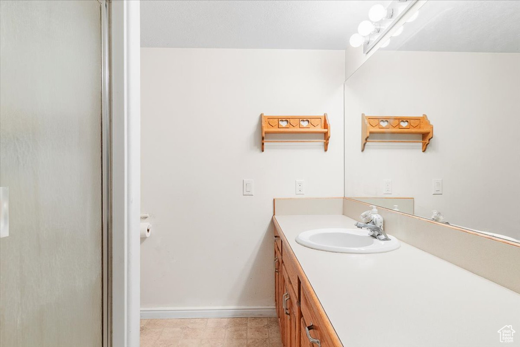 Bathroom featuring vanity and tile patterned floors