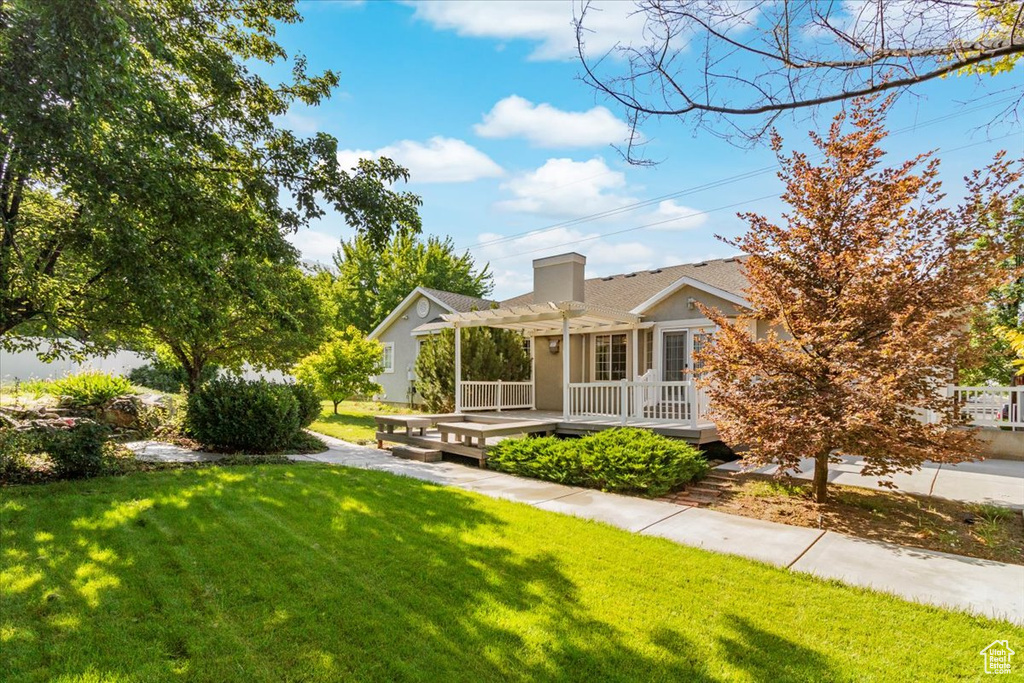 Exterior space featuring a pergola and a front lawn